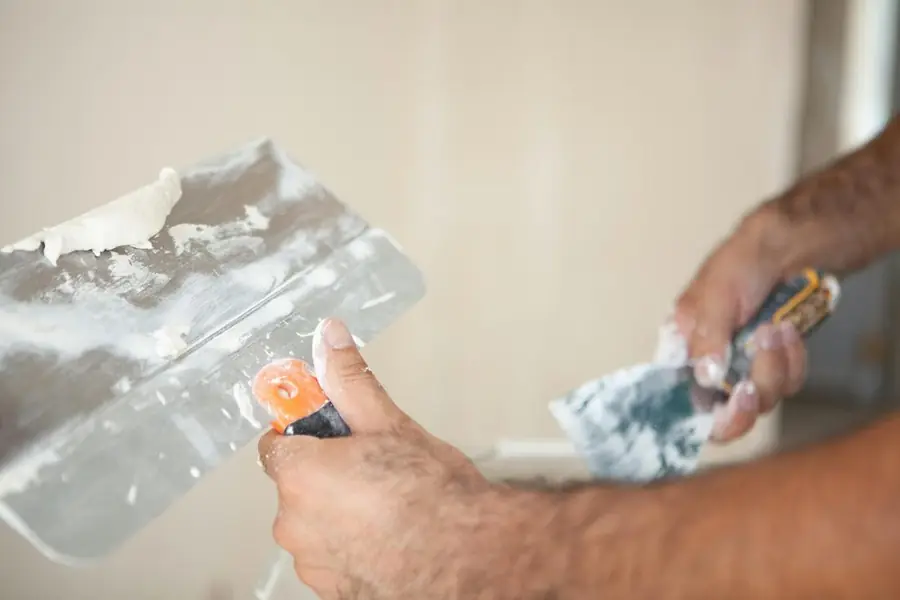 Artisan appliquant un enduit au couteau